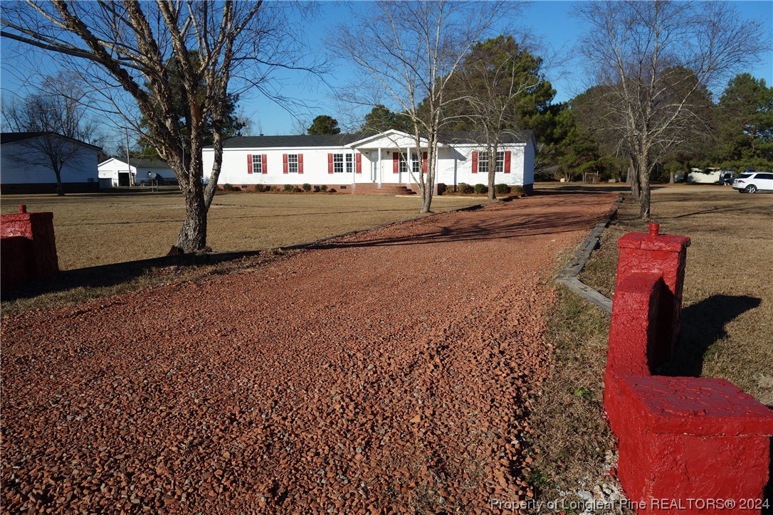 3001 Popes Crossing Road Lumberton, NC 28358 - Photo 1 of 43 a street view along with residential houses