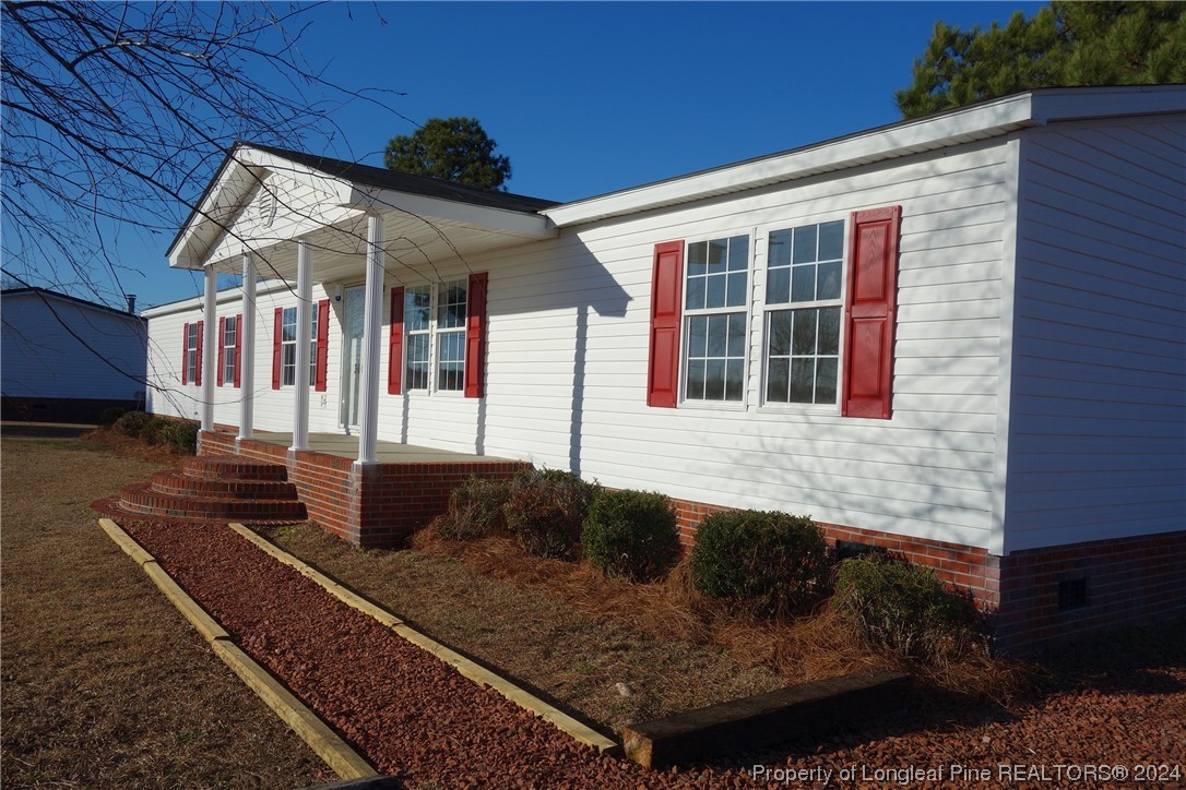 3001 Popes Crossing Road Lumberton, NC 28358 - Photo 11 of 43 a front view of a house with a yard