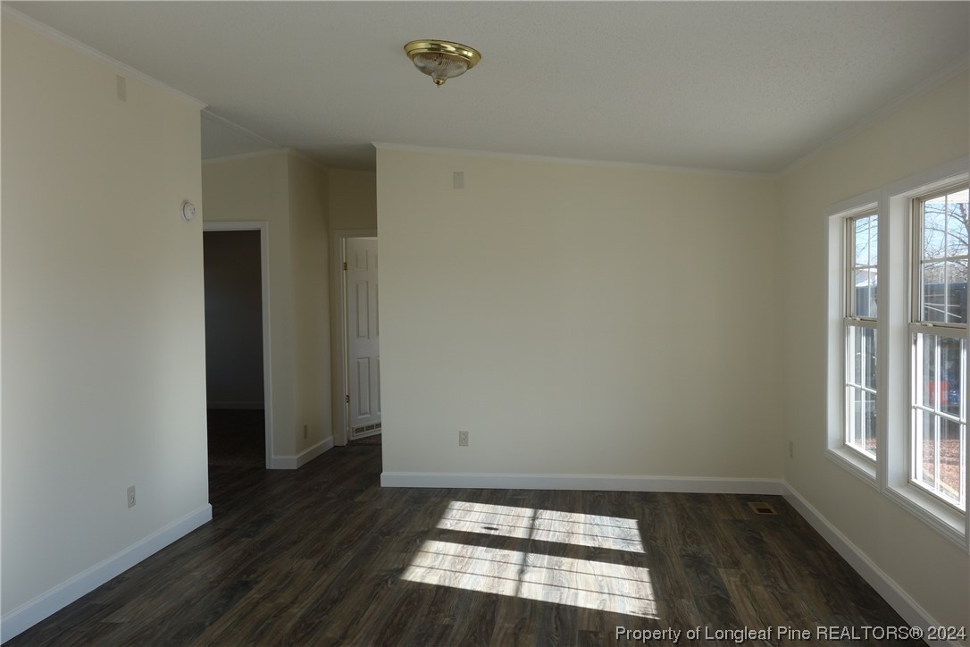 3001 Popes Crossing Road Lumberton, NC 28358 - Photo 20 of 43 an empty room with wooden floor and windows