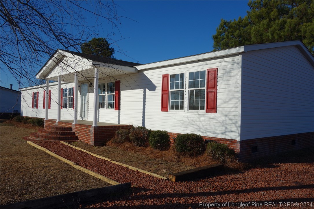 3001 Popes Crossing Road Lumberton, NC 28358 - Photo 2 of 43 a front view of a house with garden