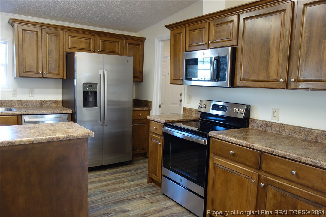 3001 Popes Crossing Road Lumberton, NC 28358 - Photo 4 of 43 a kitchen with stainless steel appliances granite countertop a refrigerator stove and sink
