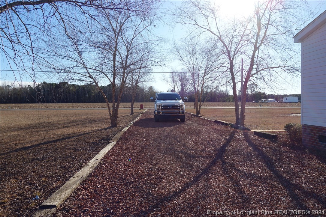3001 Popes Crossing Road Lumberton, NC 28358 - Photo 41 of 43 a backyard of a house with lots of green space