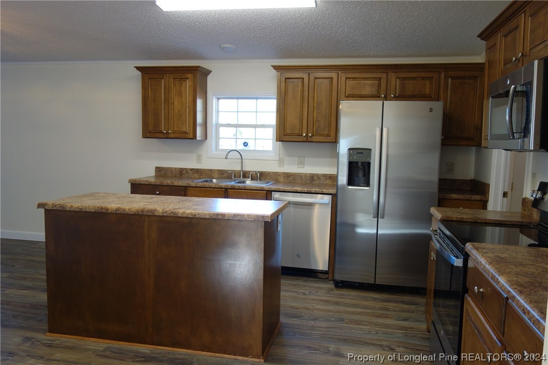 3001 Popes Crossing Road Lumberton, NC 28358 - Photo 5 of 43 a kitchen with stainless steel appliances granite countertop a refrigerator a sink a stove and island