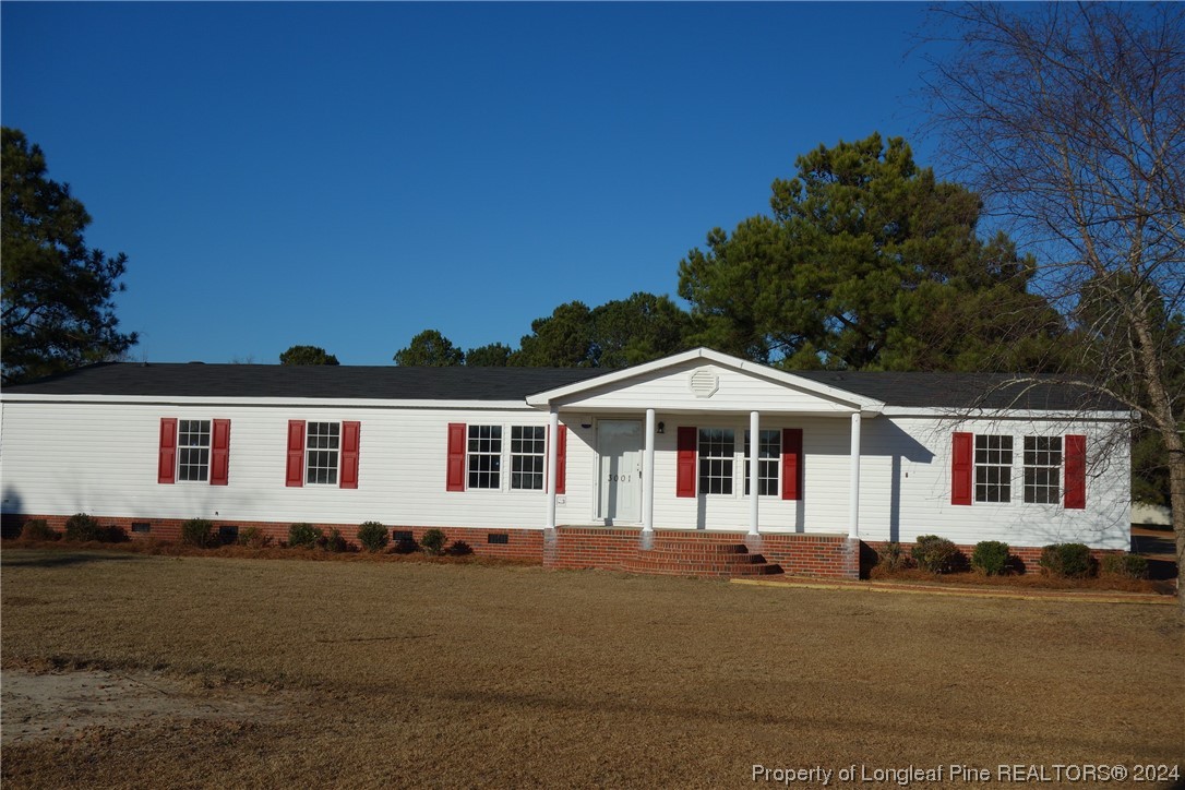 3001 Popes Crossing Road Lumberton, NC 28358 - Photo 10 of 43 a front view of a house with a yard