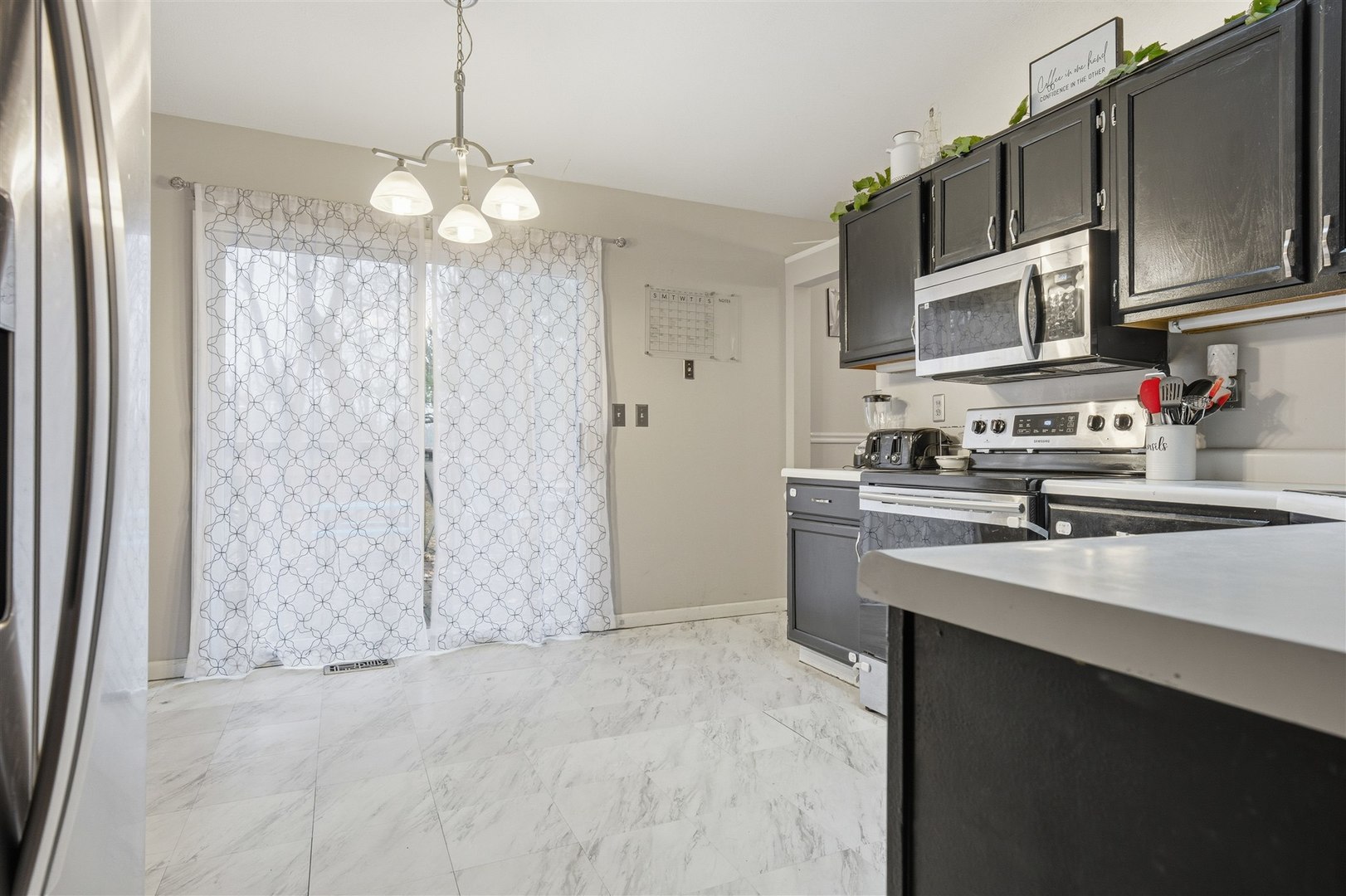 901 Charlotte Drive Normal, IL 61761 - Photo 11 of 32 a kitchen with stainless steel appliances granite countertop a sink a stove a refrigerator and cabinets