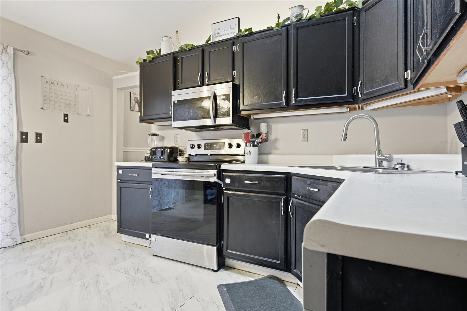 901 Charlotte Drive Normal, IL 61761 - Photo 12 of 32 a kitchen with a sink a stove and microwave