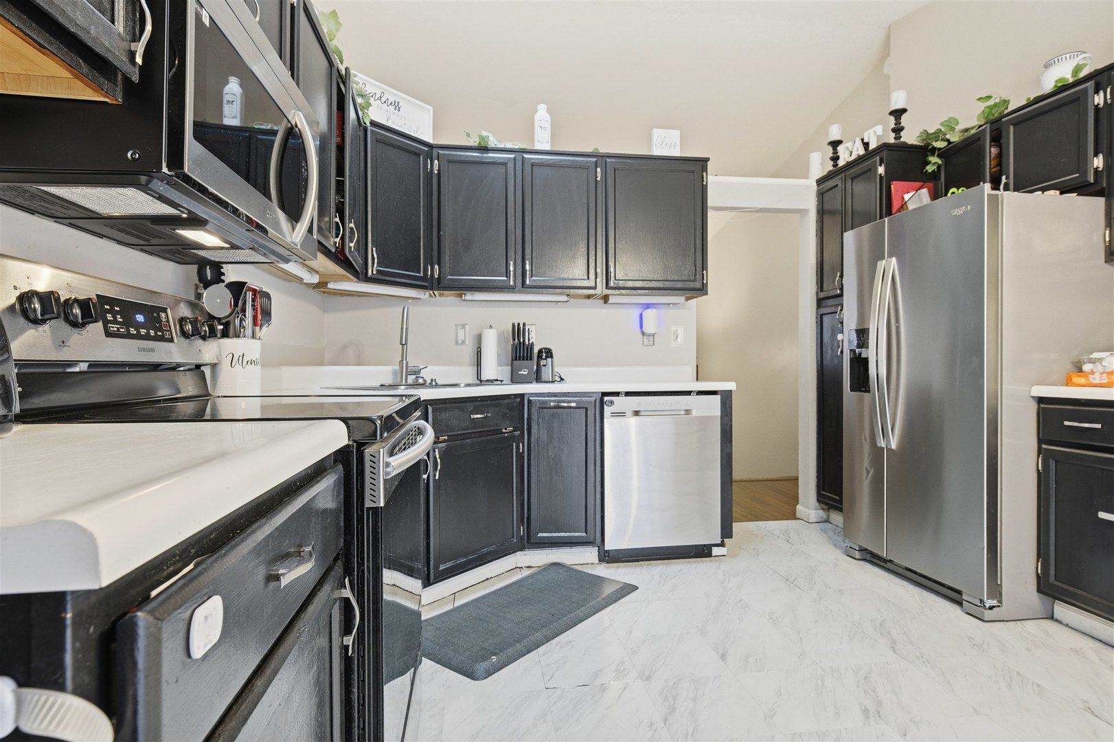 901 Charlotte Drive Normal, IL 61761 - Photo 13 of 32 a kitchen with stainless steel appliances granite countertop a refrigerator a stove and a sink with wooden cabinets