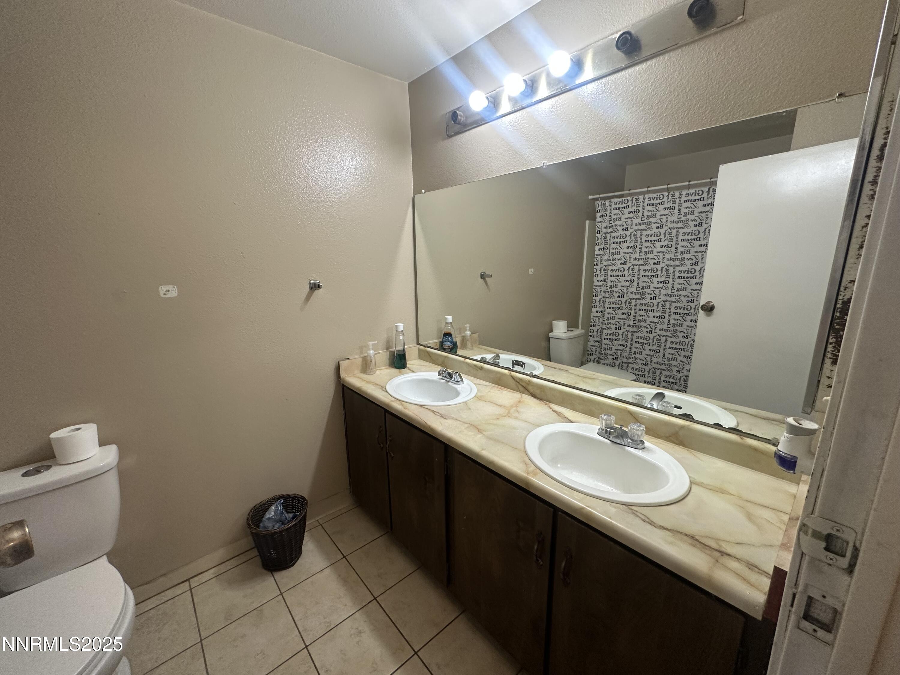 863 Nutmeg Place, Unit 12 Reno, NV 89502 - Photo 13 of 31 a bathroom with a sink toilet and mirror