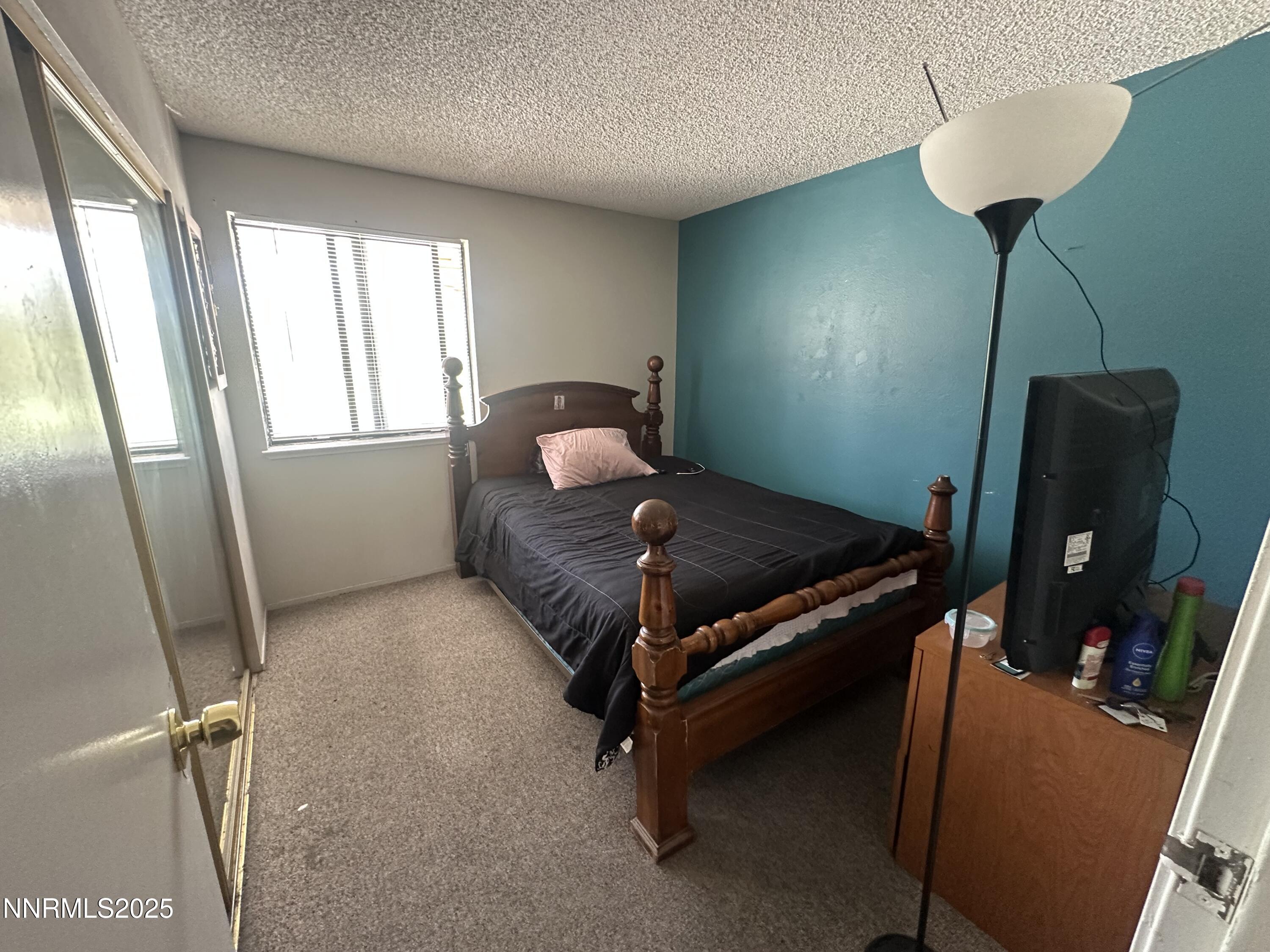 863 Nutmeg Place, Unit 12 Reno, NV 89502 - Photo 14 of 31 a bedroom with furniture and a window