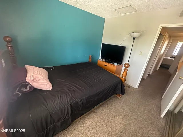a bedroom with a bed and flat screen tv