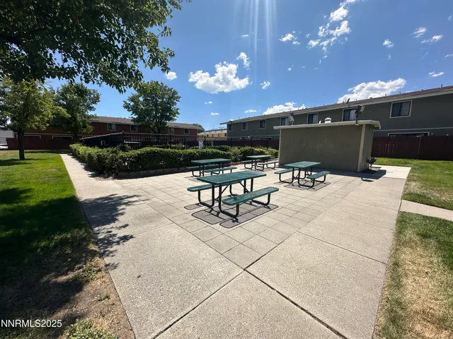 a view of a patio with couches table and chairs with plants