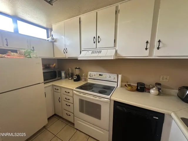 a kitchen with cabinets appliances and a sink