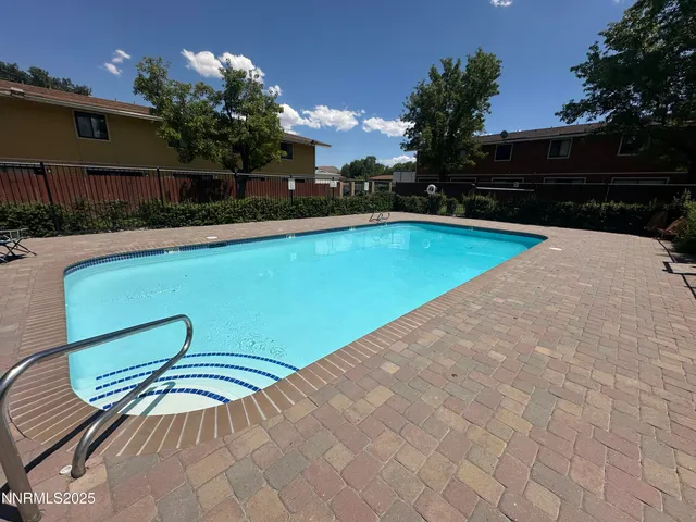 a view of a swimming pool with a yard