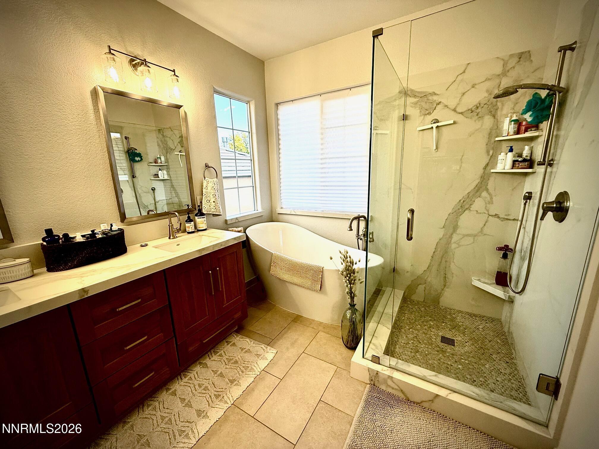1771 Emerald Bay Drive Reno, NV 89521 - Photo 16 of 31 a bathroom with double vanity sink a mirror and a shower