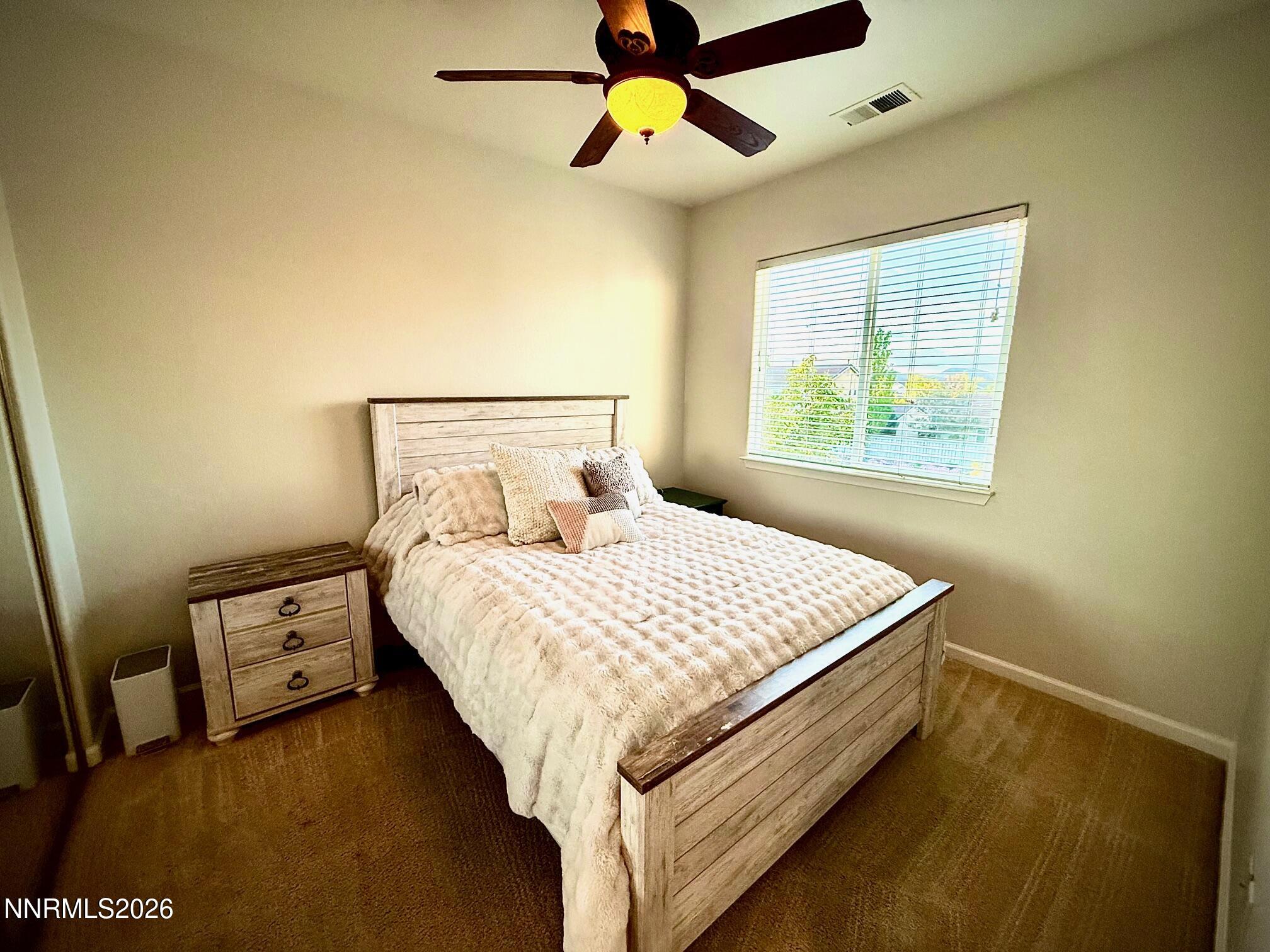 1771 Emerald Bay Drive Reno, NV 89521 - Photo 22 of 31 a bed sitting in a bedroom next to a window