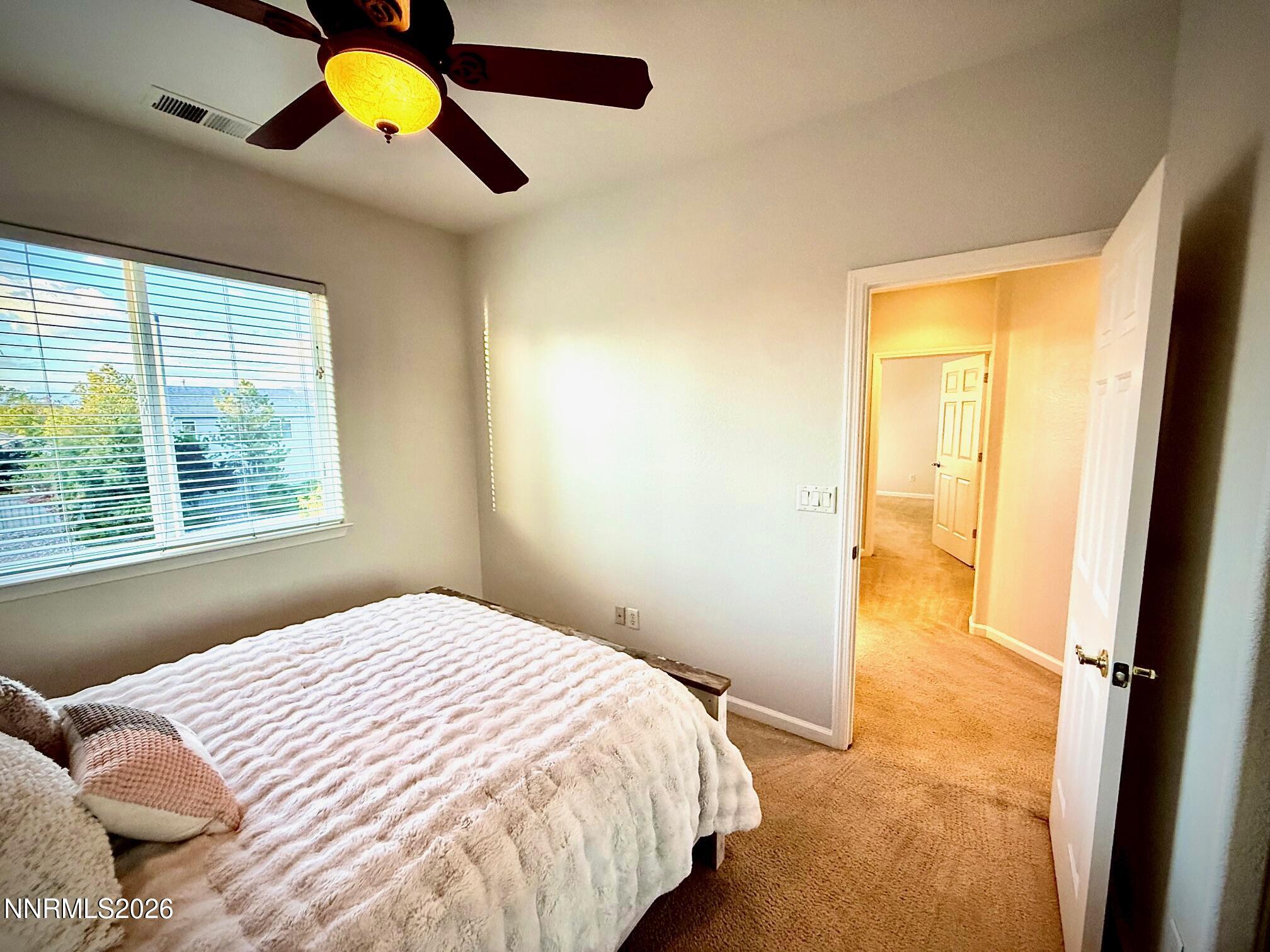 1771 Emerald Bay Drive Reno, NV 89521 - Photo 23 of 31 a bedroom with a bed and a window