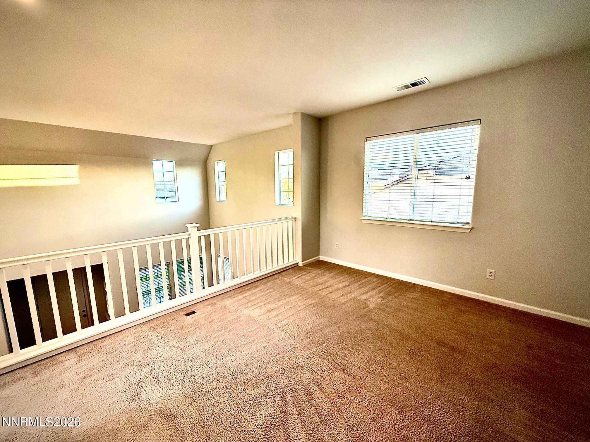 1771 Emerald Bay Drive Reno, NV 89521 - Photo 26 of 31 a view of an empty room with wooden floor and a window