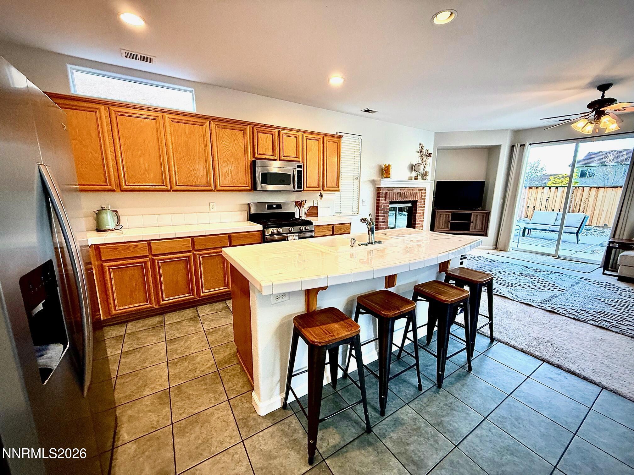1771 Emerald Bay Drive Reno, NV 89521 - Photo 6 of 31 a kitchen with granite countertop a stove a sink a dining table and chairs