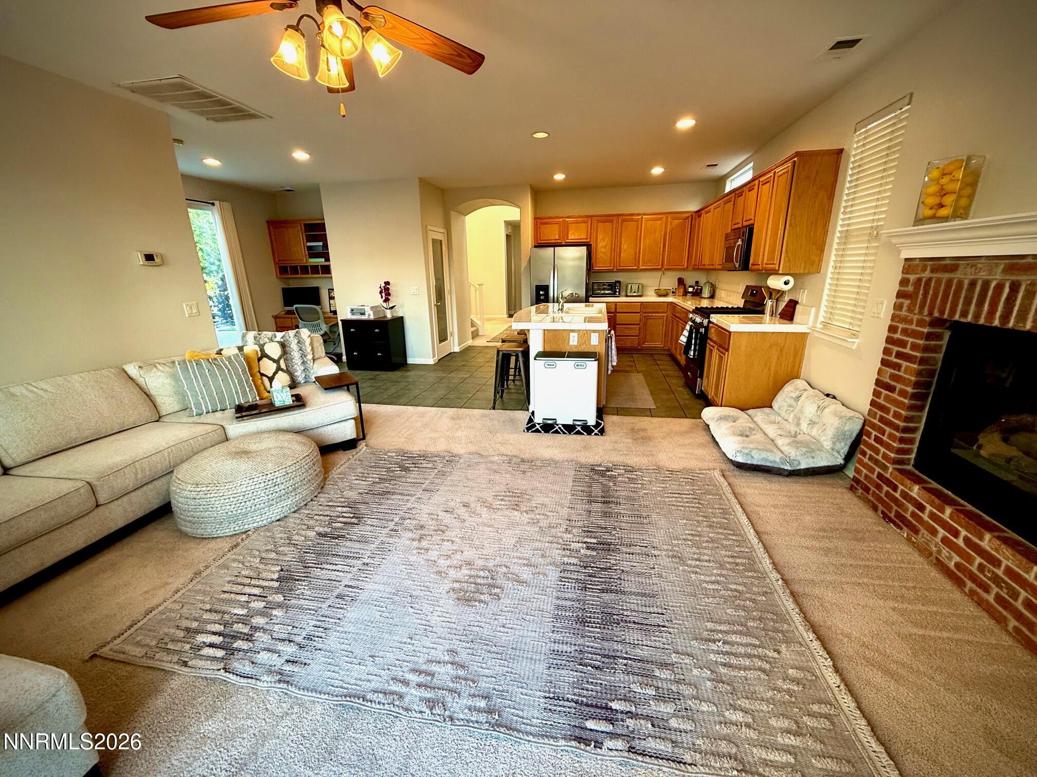 1771 Emerald Bay Drive Reno, NV 89521 - Photo 8 of 31 a living room with furniture and a fireplace