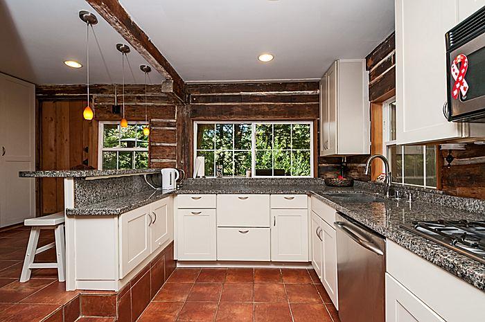 47 Skylonda Drive Woodside, CA 94062 - Photo 9 of 16 a kitchen with a sink stove and cabinets