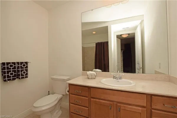 a white toilet sitting next to a shower curtain