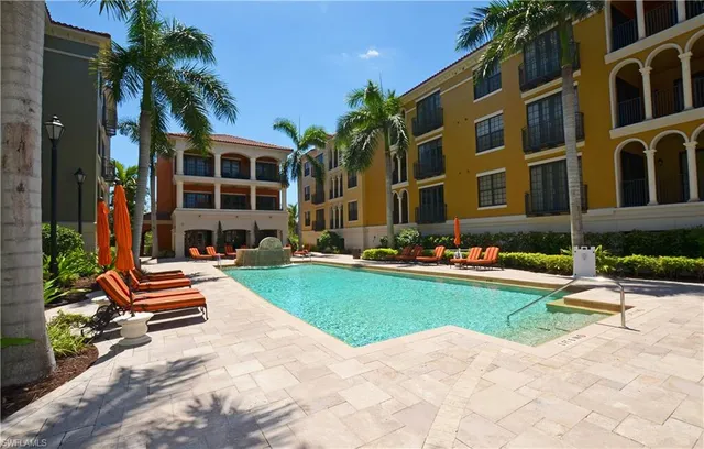 a view of a swimming pool with lounge chair
