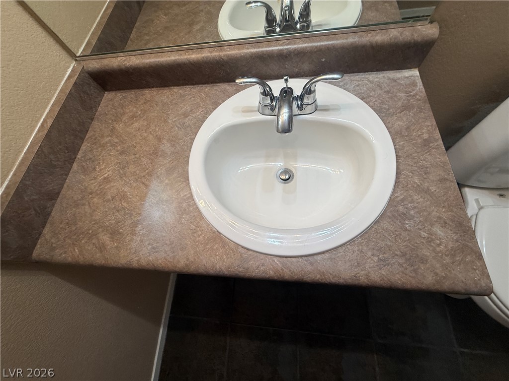 7255 West Sunset Road, Unit 2052 Las Vegas, NV 89113 - Photo 16 of 16 A classic bathroom vanity offers a functional sink and ample counter space.