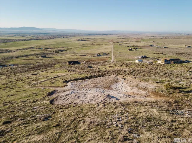 an aerial view of ocean and trees