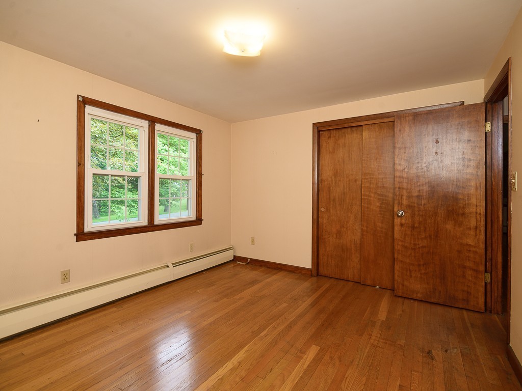 19 8 Lots Road Sutton, MA 01590 - Photo 18 of 30 an empty room with wooden floor and windows
