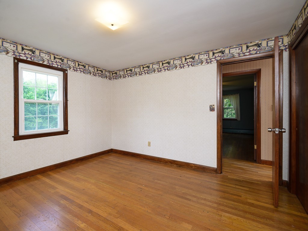 19 8 Lots Road Sutton, MA 01590 - Photo 21 of 30 a view of an empty room with wooden floor and a window