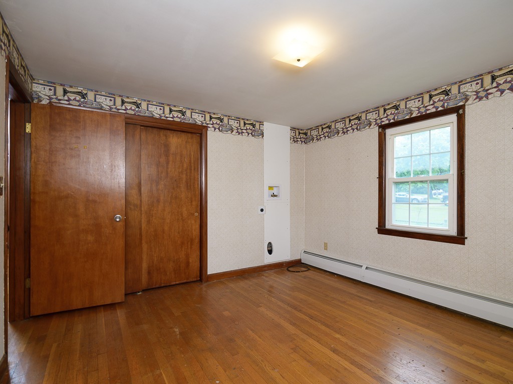19 8 Lots Road Sutton, MA 01590 - Photo 22 of 30 a view of an empty room with wooden floor and a window