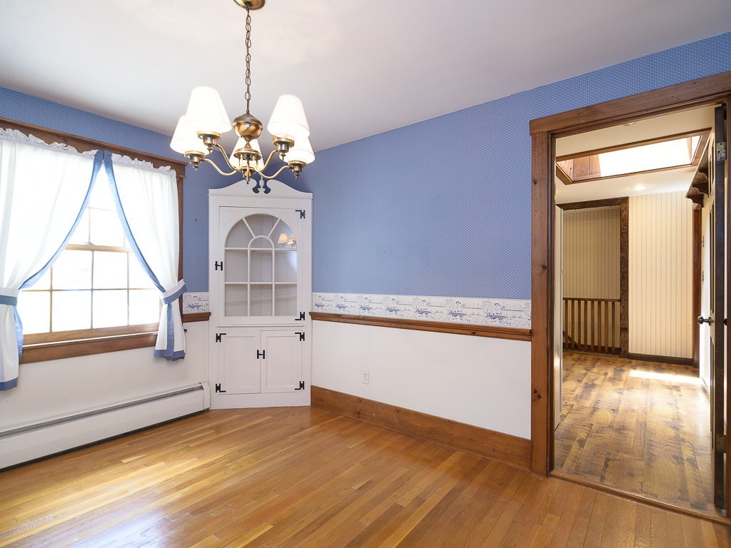 19 8 Lots Road Sutton, MA 01590 - Photo 8 of 30 a view of a room with window wooden floor and a chandelier