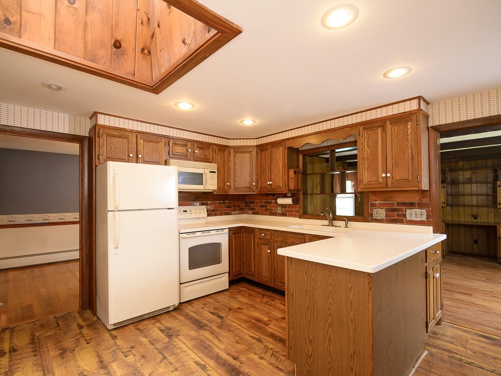 19 8 Lots Road Sutton, MA 01590 - Photo 10 of 30 a kitchen with appliances a sink and a refrigerator