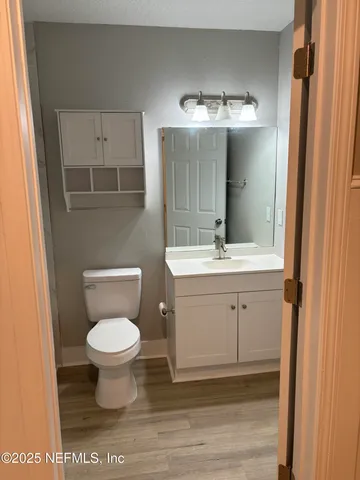 a bathroom with a sink toilet and a mirror