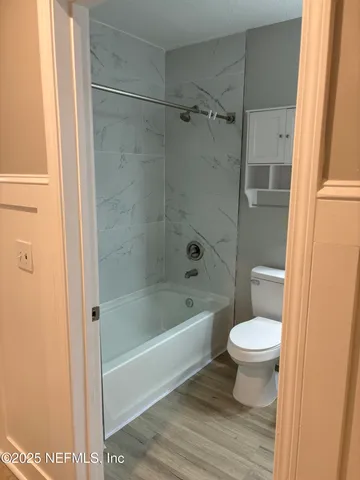 a bathroom with a toilet and a shower