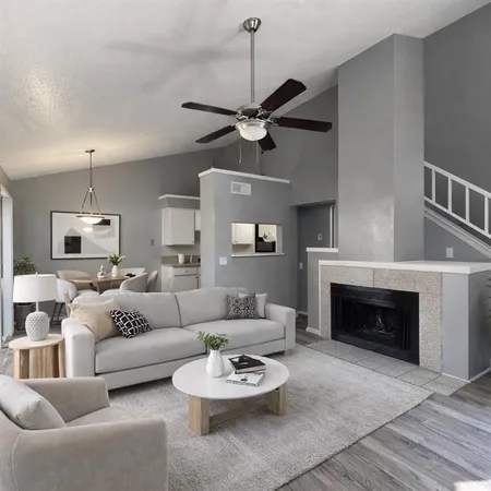 a living room with furniture a fireplace and a chandelier