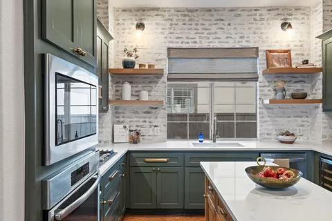 a kitchen with a sink cabinets and stainless steel appliances