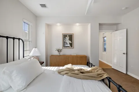 a bedroom with furniture and a window