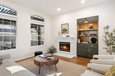 a living room with furniture window and fireplace