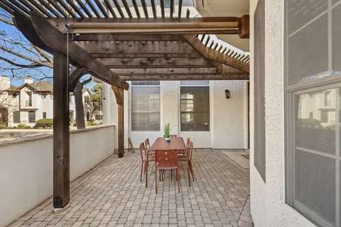 a view of balcony with two chairs and a potted plant on a table