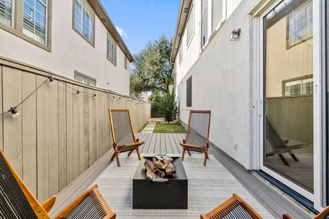 a balcony with furniture and wooden floor