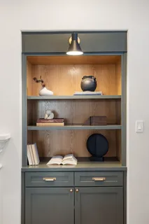 a shelf with cup and plates