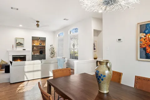 a living room with fireplace furniture and a wooden floor
