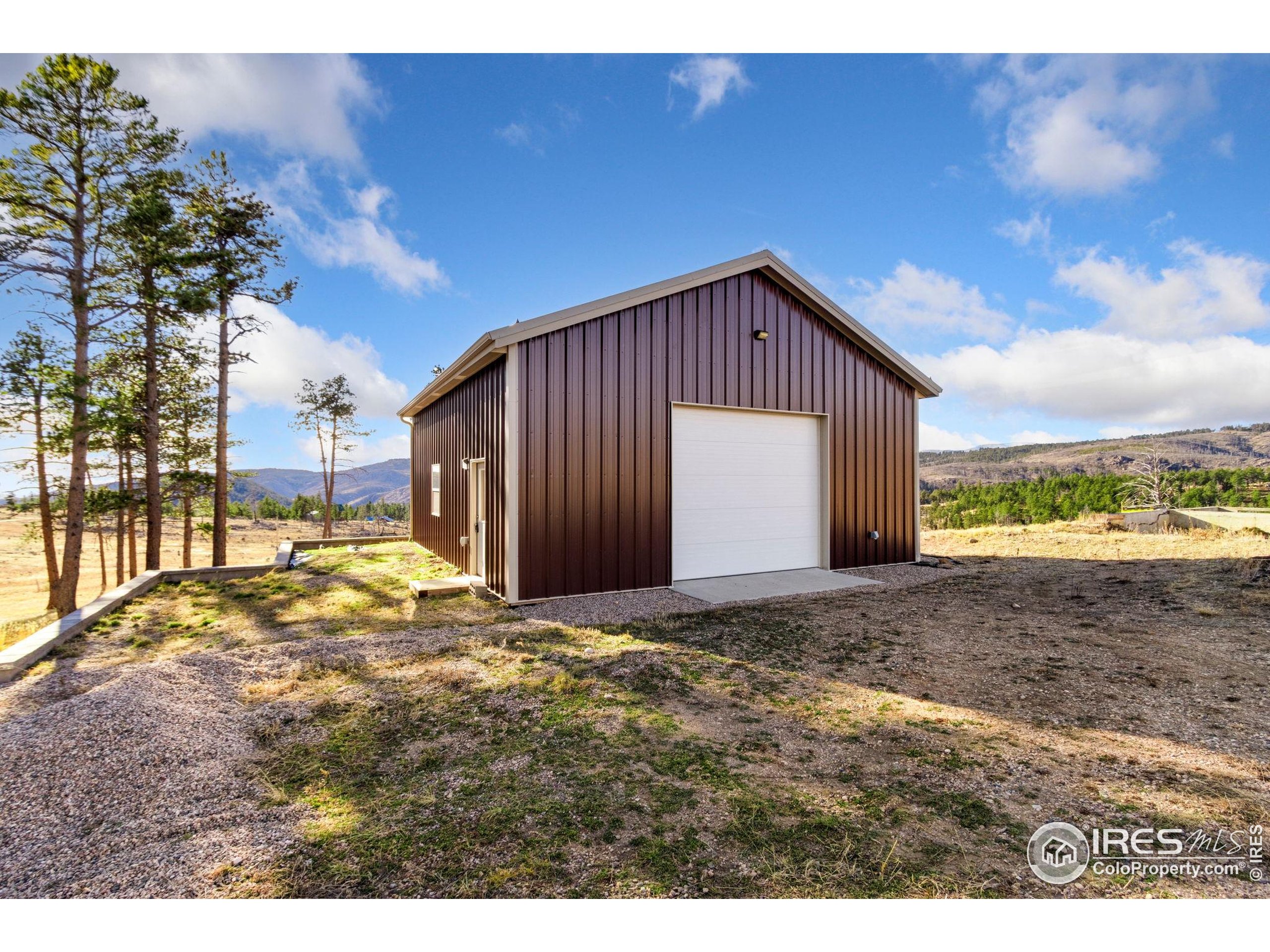 3434 Davis Ranch Road Bellvue, CO 80512 - Photo 7 of 30 a view of a house with a backyard