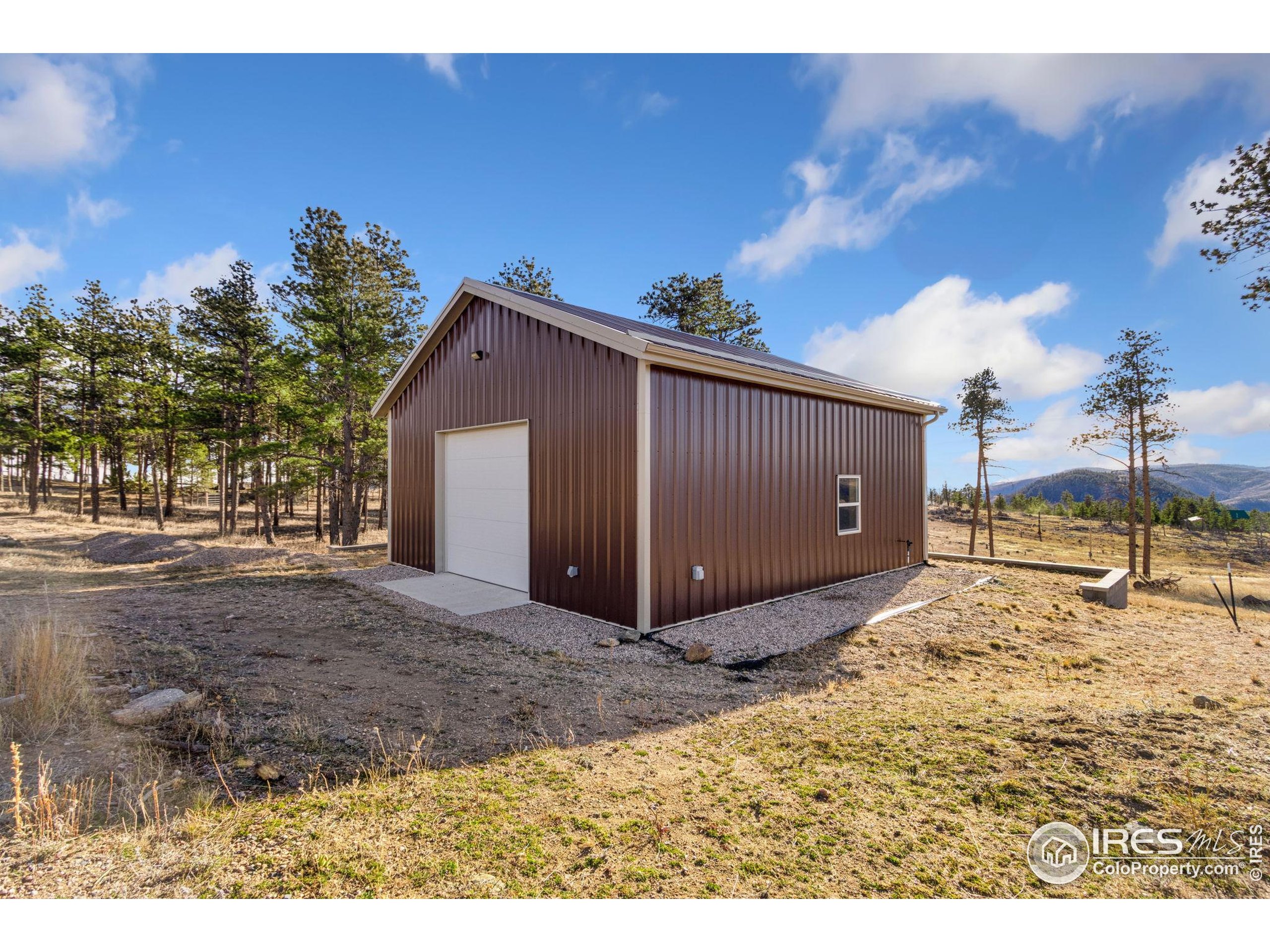 3434 Davis Ranch Road Bellvue, CO 80512 - Photo 8 of 30 a view of a house with a backyard