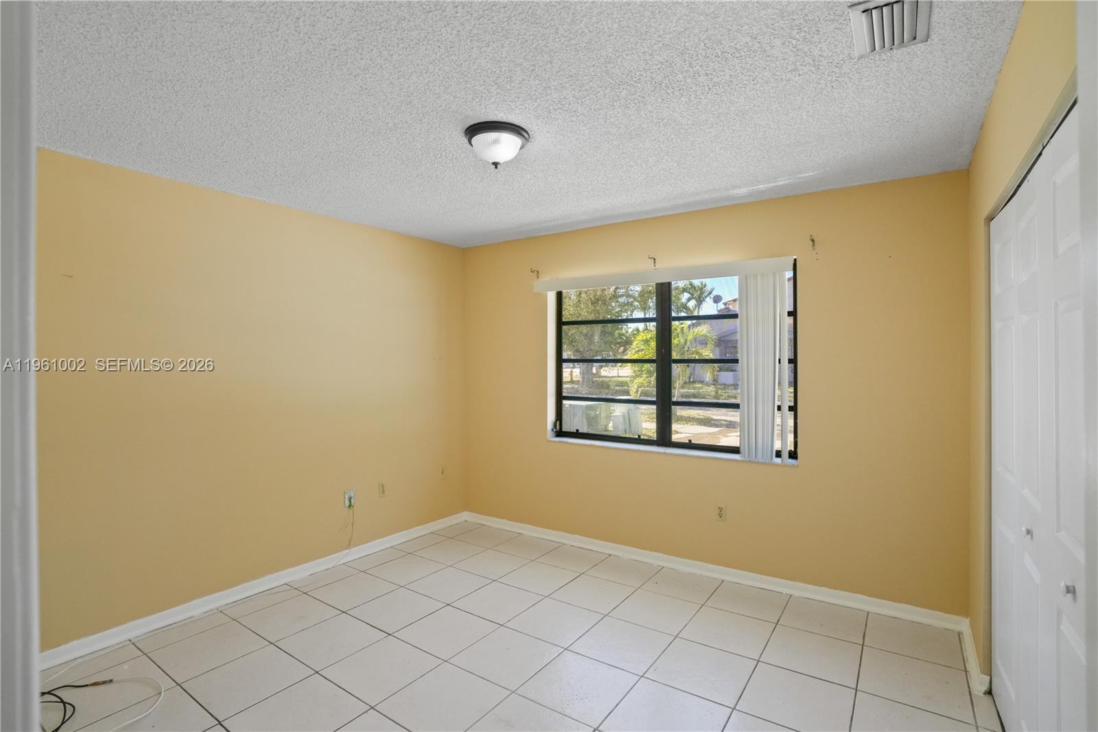 6227 Southwest 135th Avenue Miami, FL 33183 - Photo 12 of 24 a view of an empty room with a window