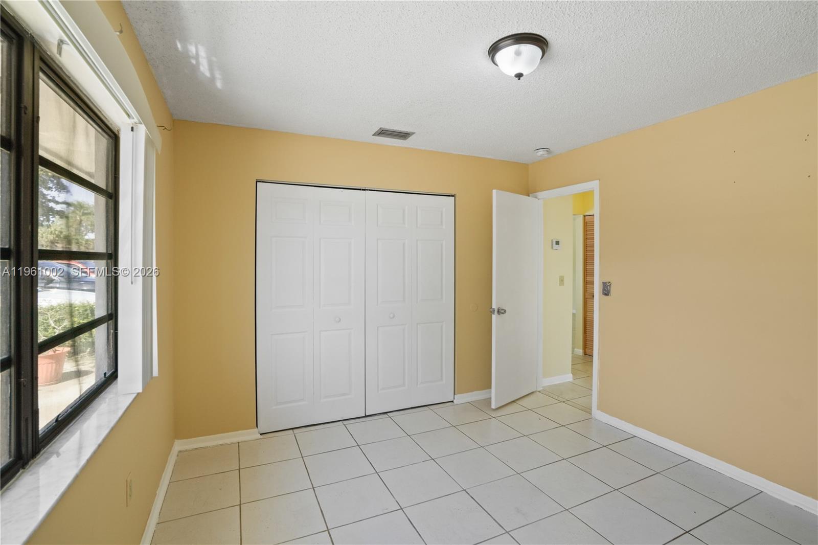 6227 Southwest 135th Avenue Miami, FL 33183 - Photo 14 of 24 a view of an empty room and window