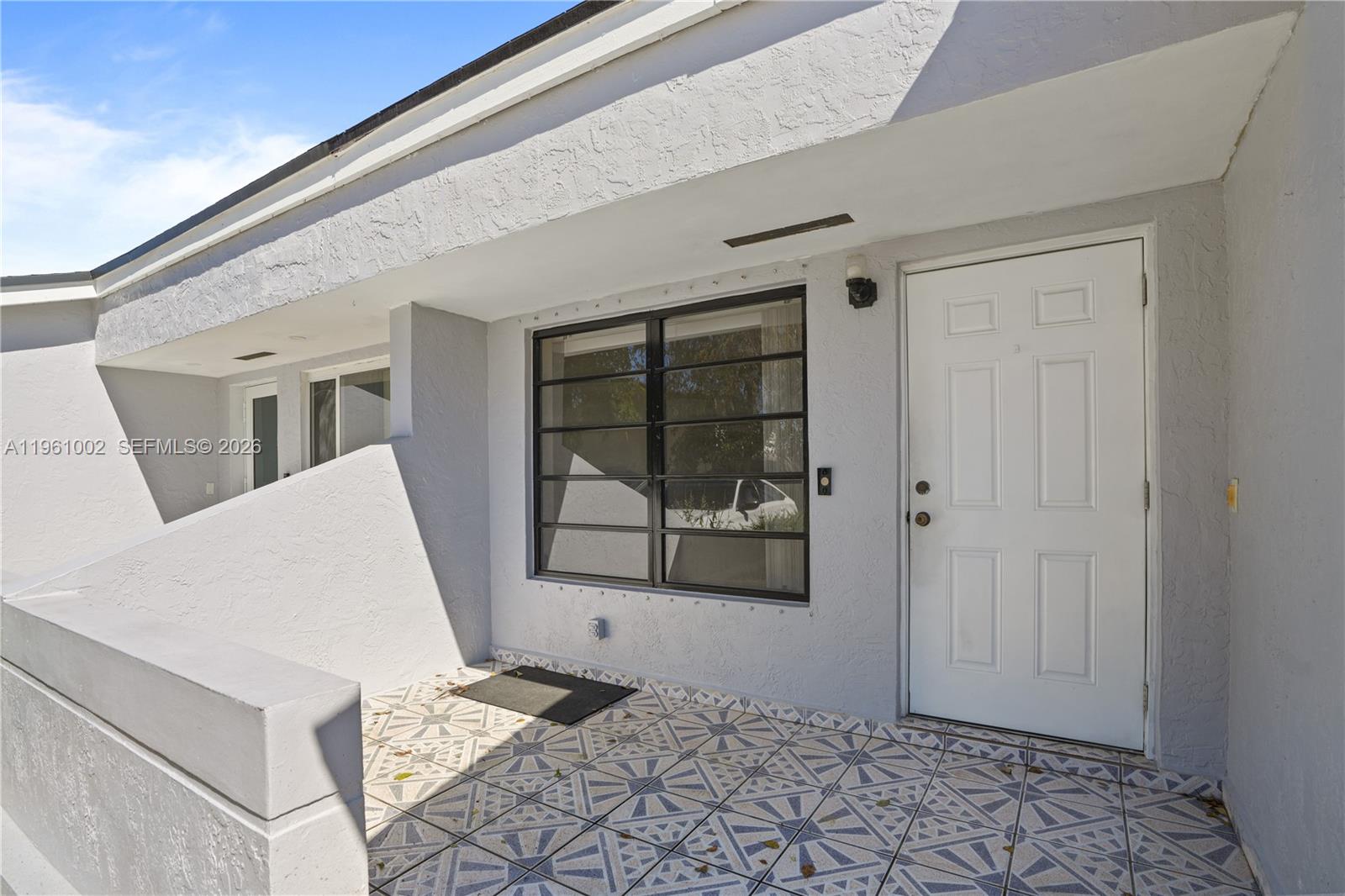 6227 Southwest 135th Avenue Miami, FL 33183 - Photo 2 of 24 a view of a hallway with wooden floor and white walls