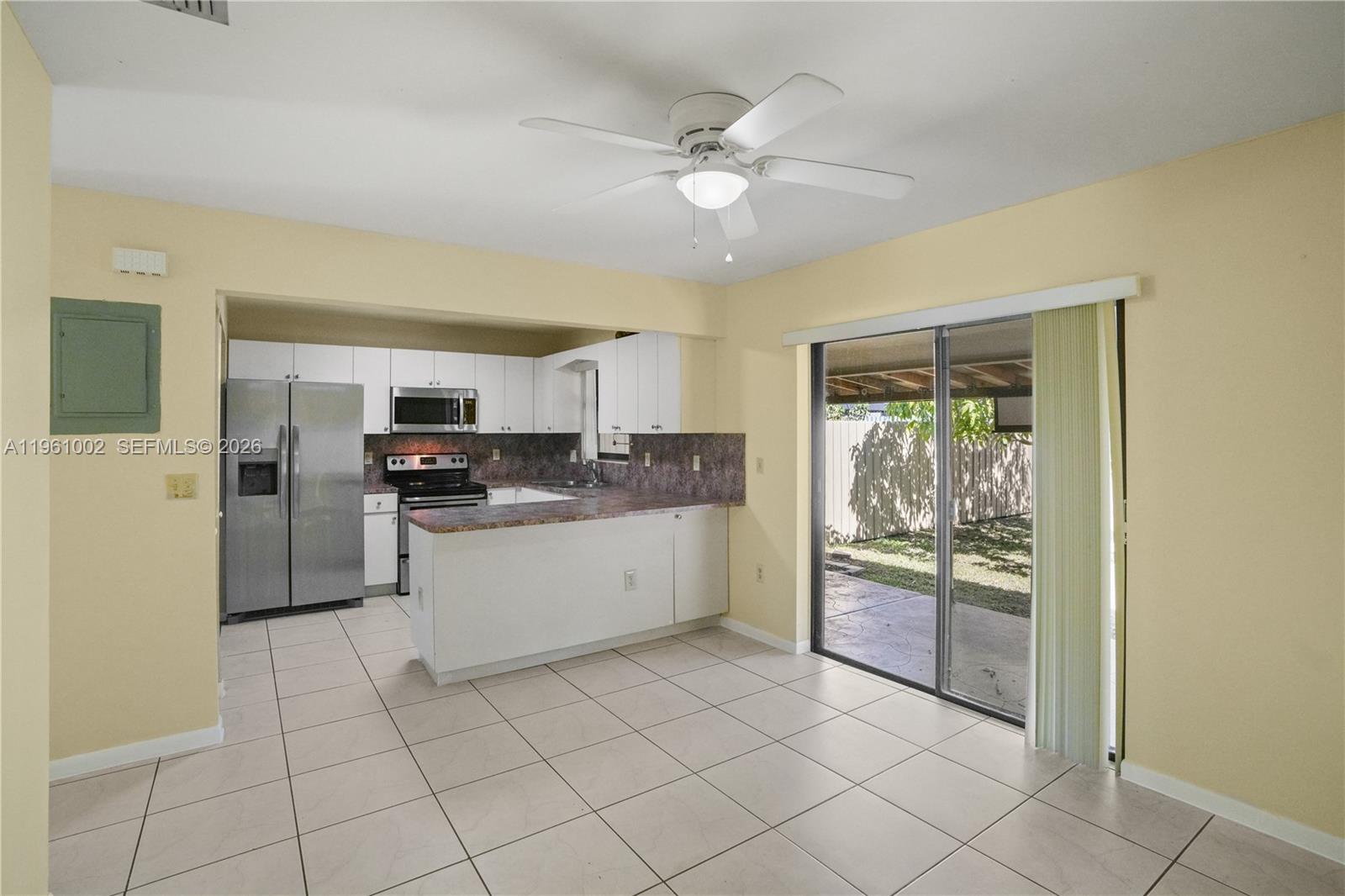 6227 Southwest 135th Avenue Miami, FL 33183 - Photo 8 of 24 a kitchen with white cabinets and white appliances