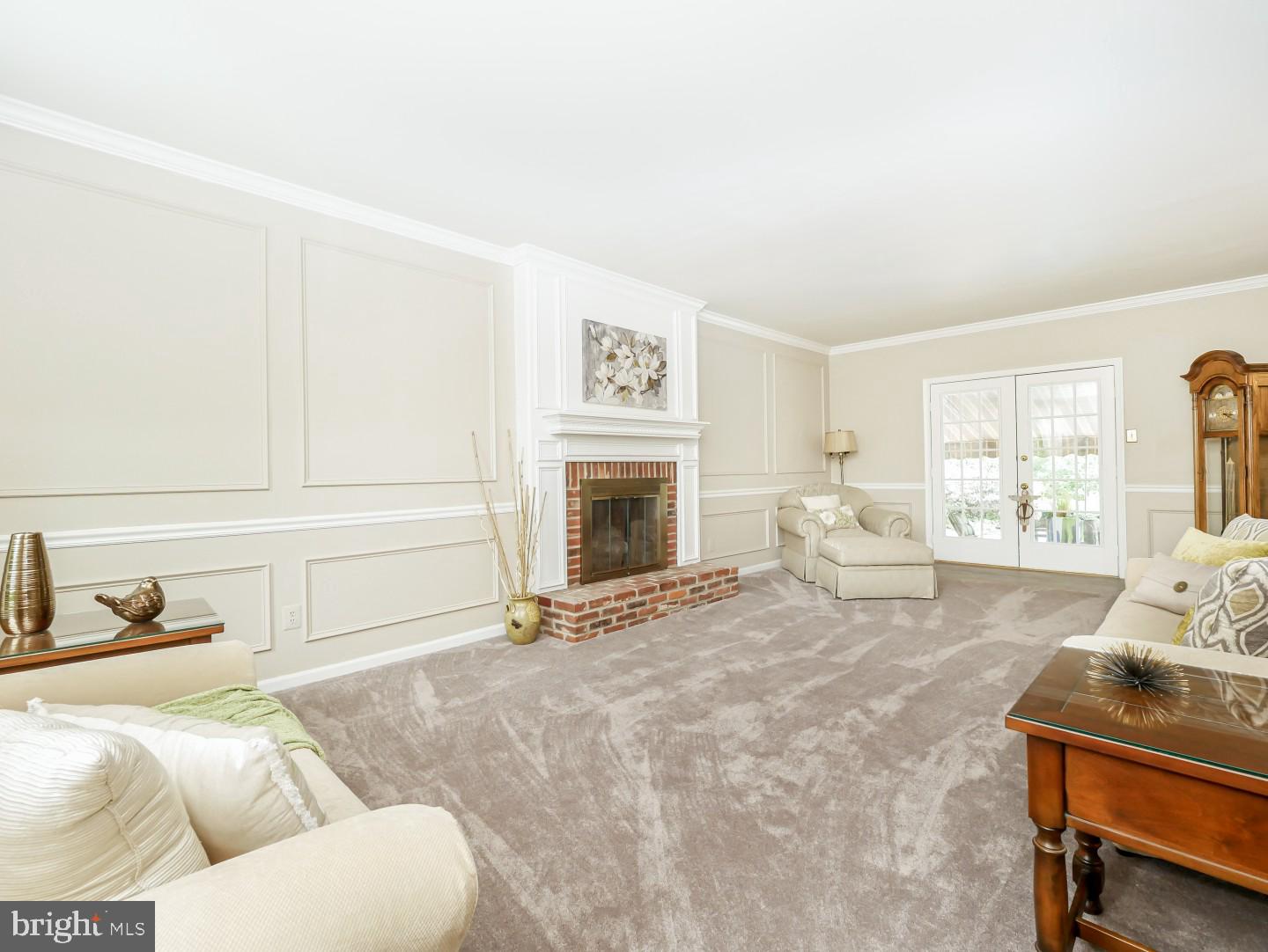 281 Cliveden Drive Newtown, PA 18940 - Photo 14 of 35 a living room with furniture a fireplace and a flat screen tv